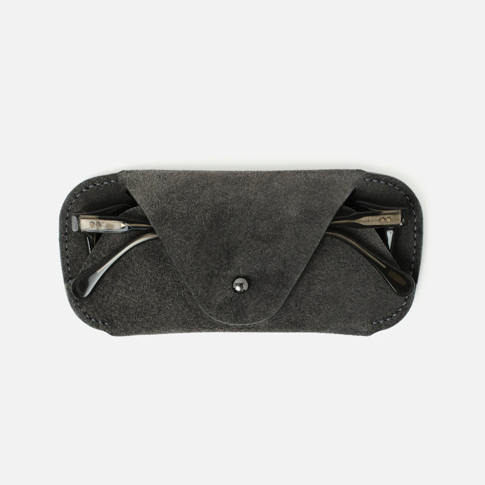 The MAKR Eyewear Sleeve V3 in Lead Horween suede with a pair of glasses inside, front view.