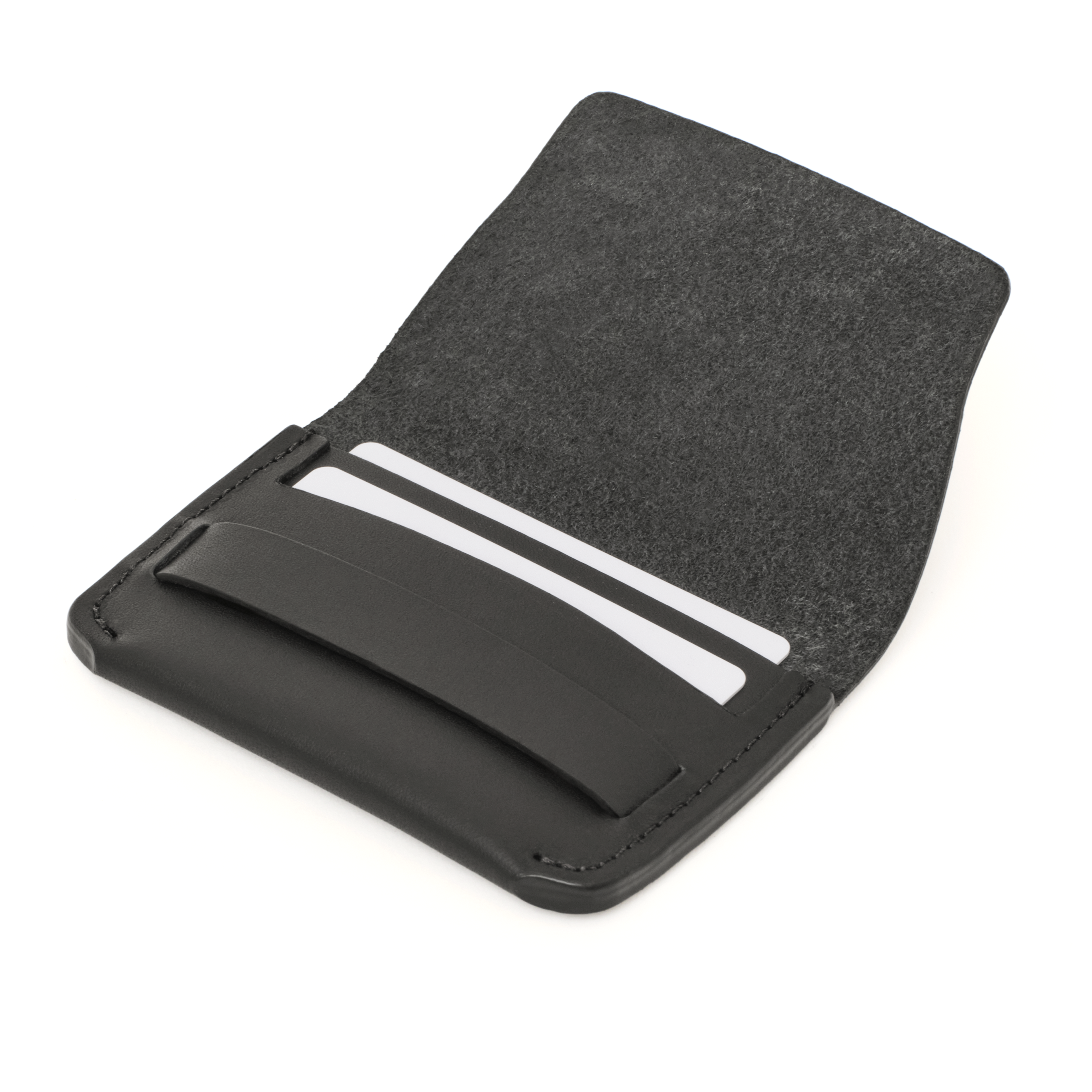 Angled view of the MAKR Flap Wallet PLUS V2 in Black Horween Latigo leather holding cards.