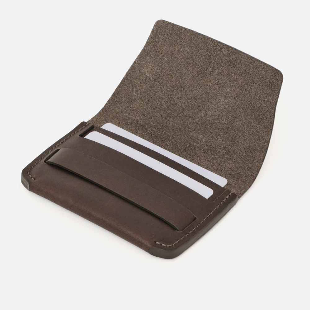Angled view of the MAKR Flap Wallet PLUS V2 in Brown Horween Latigo leather holding cards.