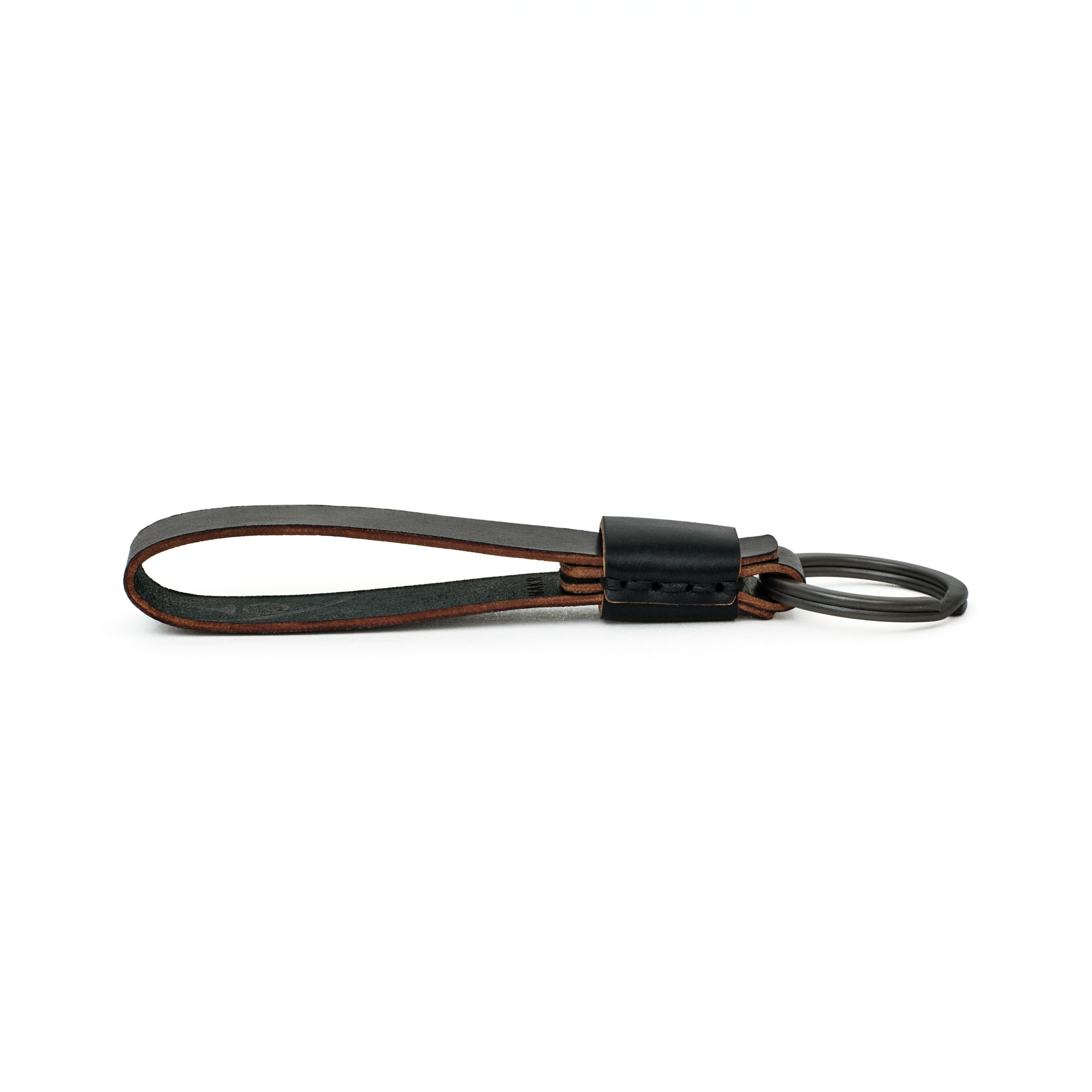 Side profile of the black cordovan Overlap Keychain showing handsewn stitching and burnished edges.