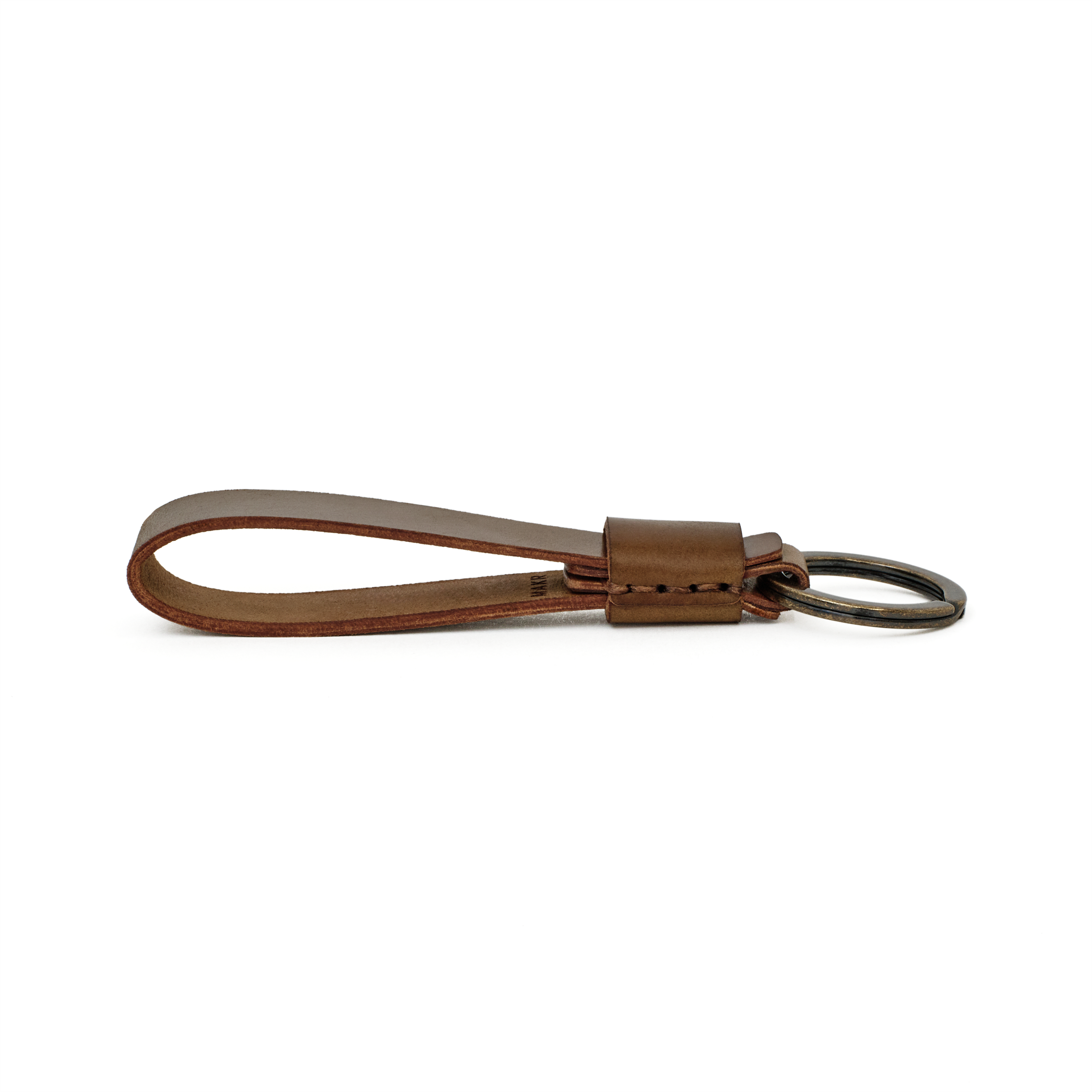 Side profile of the bourbon cordovan Overlap Keychain showing handsewn stitching and burnished edges.