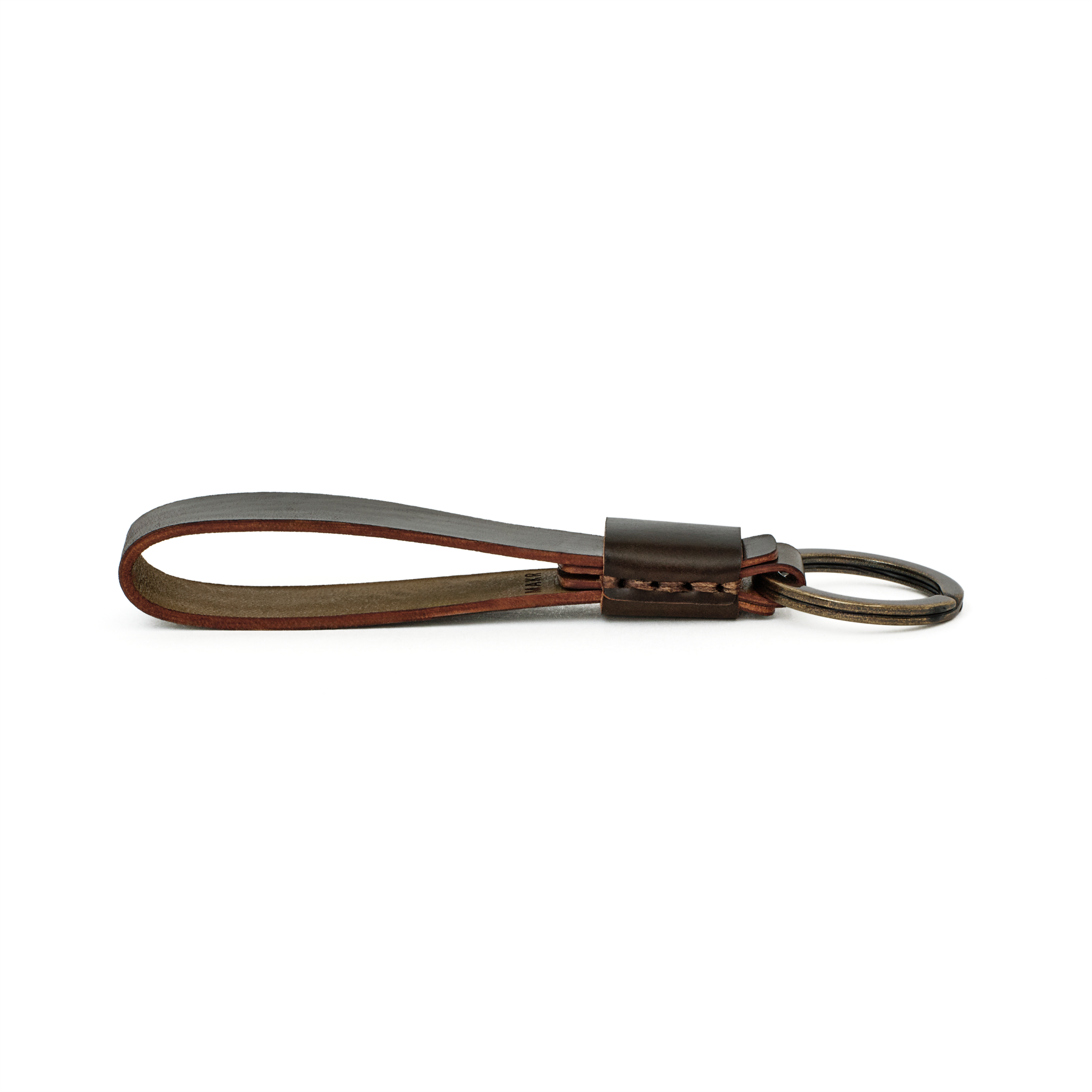 Side profile of the dark cognac cordovan Overlap Keychain showing handsewn stitching and burnished edges.