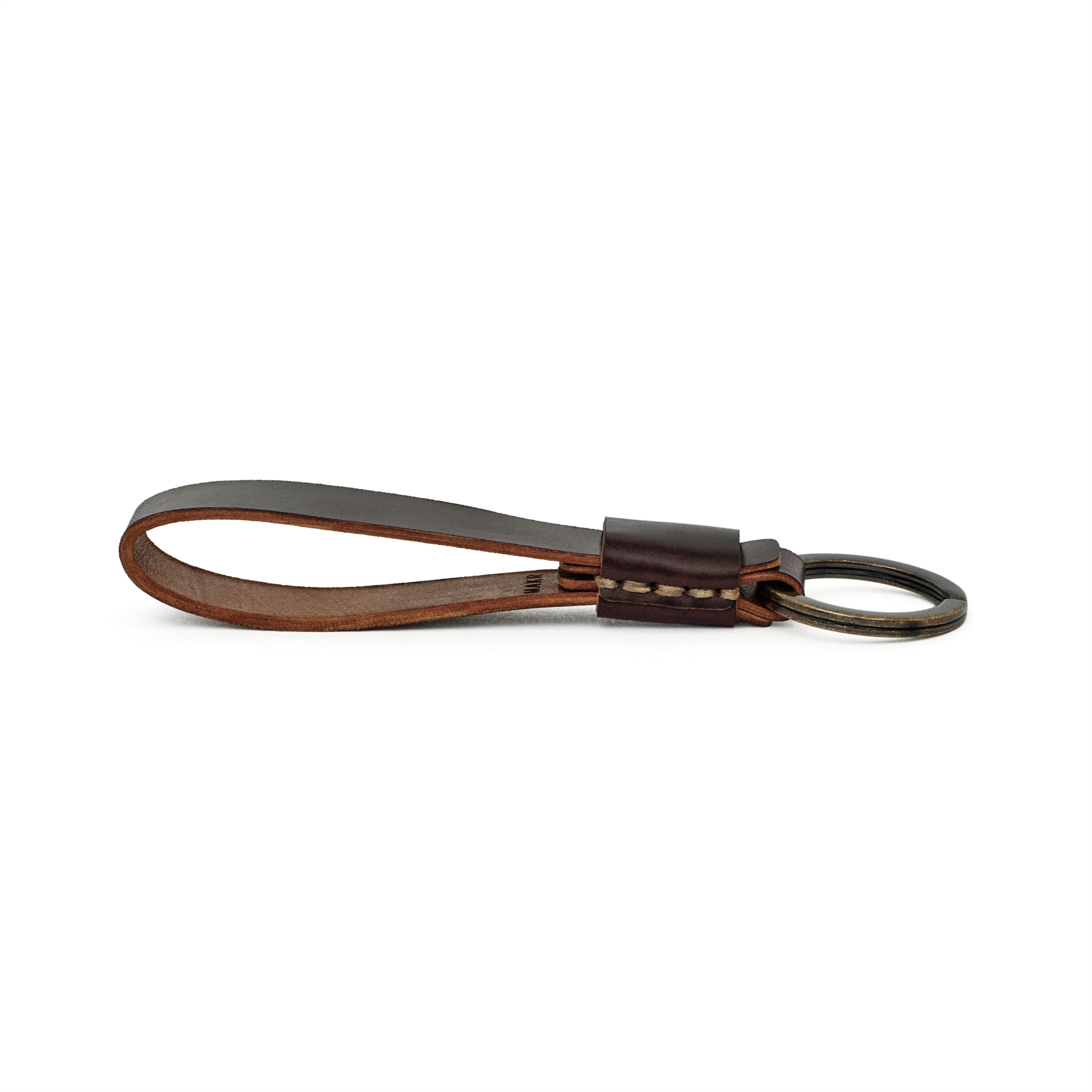 Side profile of the ox blood cordovan Overlap Keychain showing handsewn stitching and burnished edges.