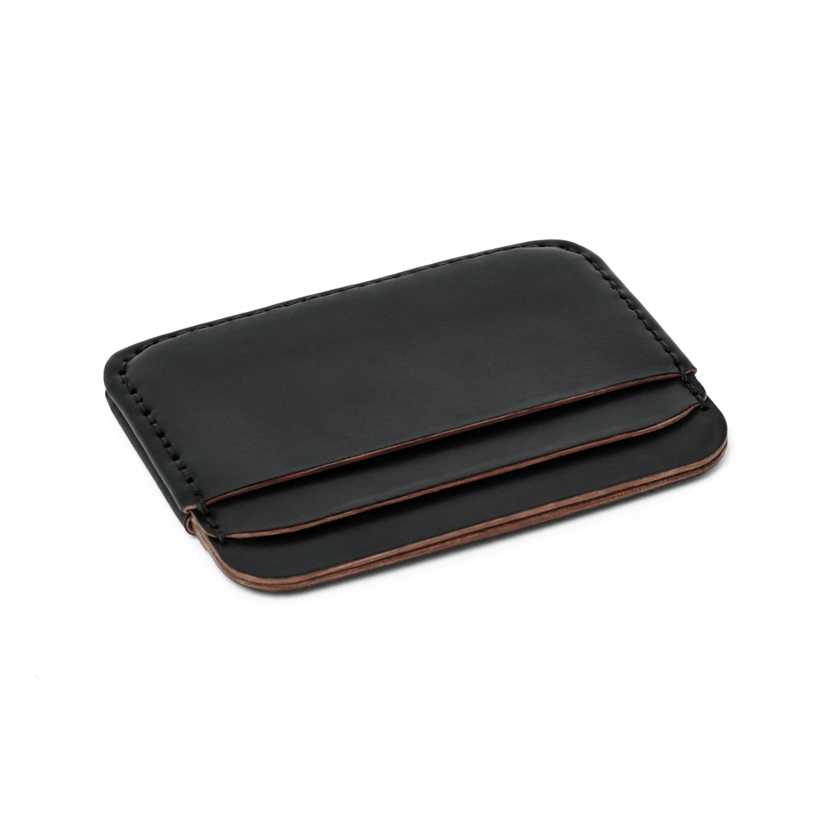 The MAKR Round Luxe PLUS Wallet in Black Horween Shell Cordovan, shown at an angle.