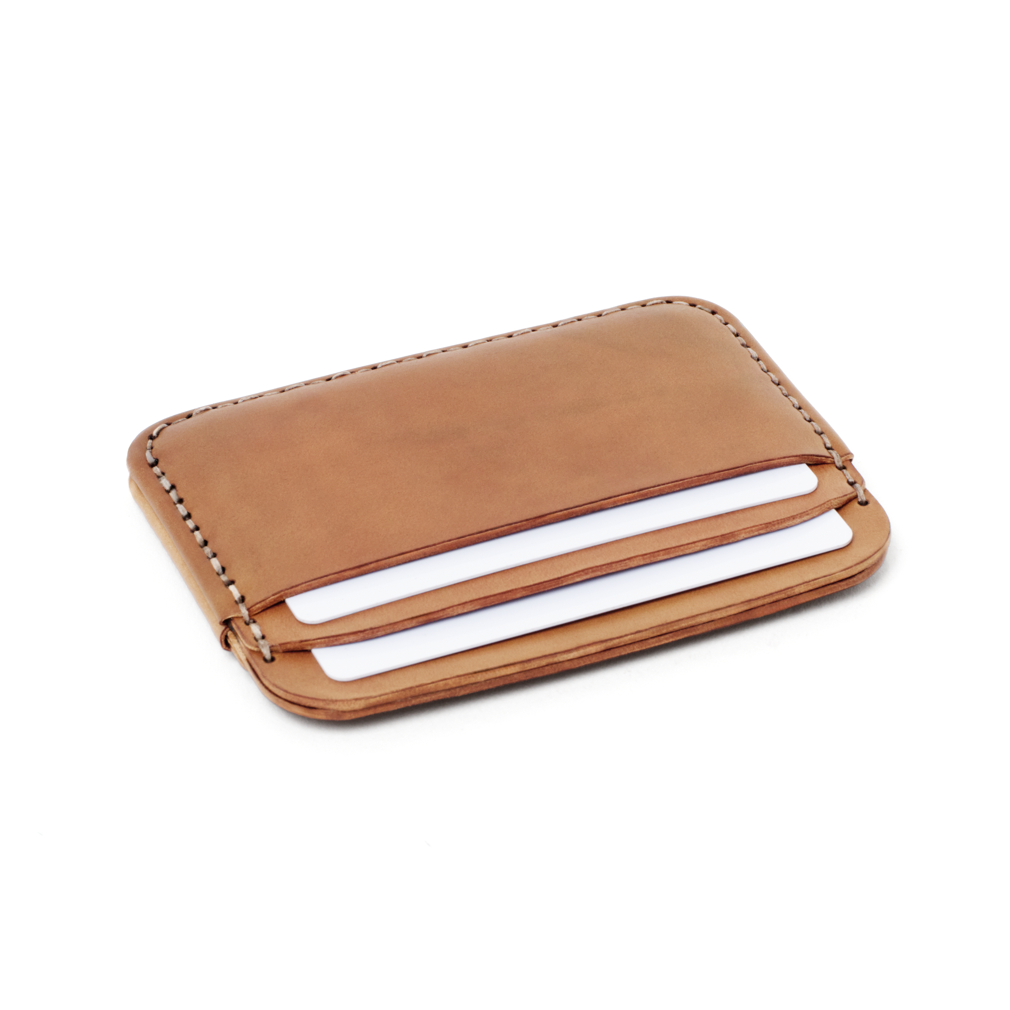 Angled view of the MAKR Round Luxe PLUS Wallet in Natural Horween Shell Cordovan holding cards.
