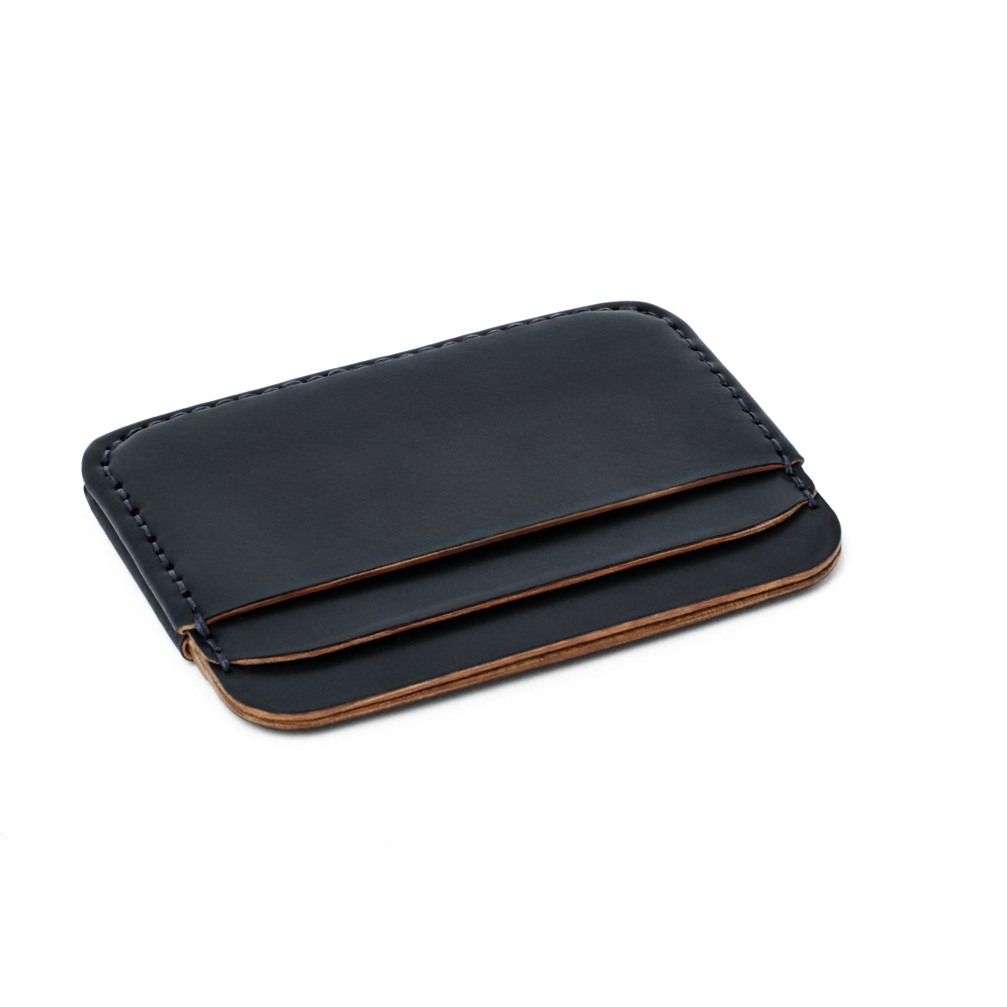 The MAKR Round Luxe PLUS Wallet in Navy Horween Shell Cordovan, shown at an angle.