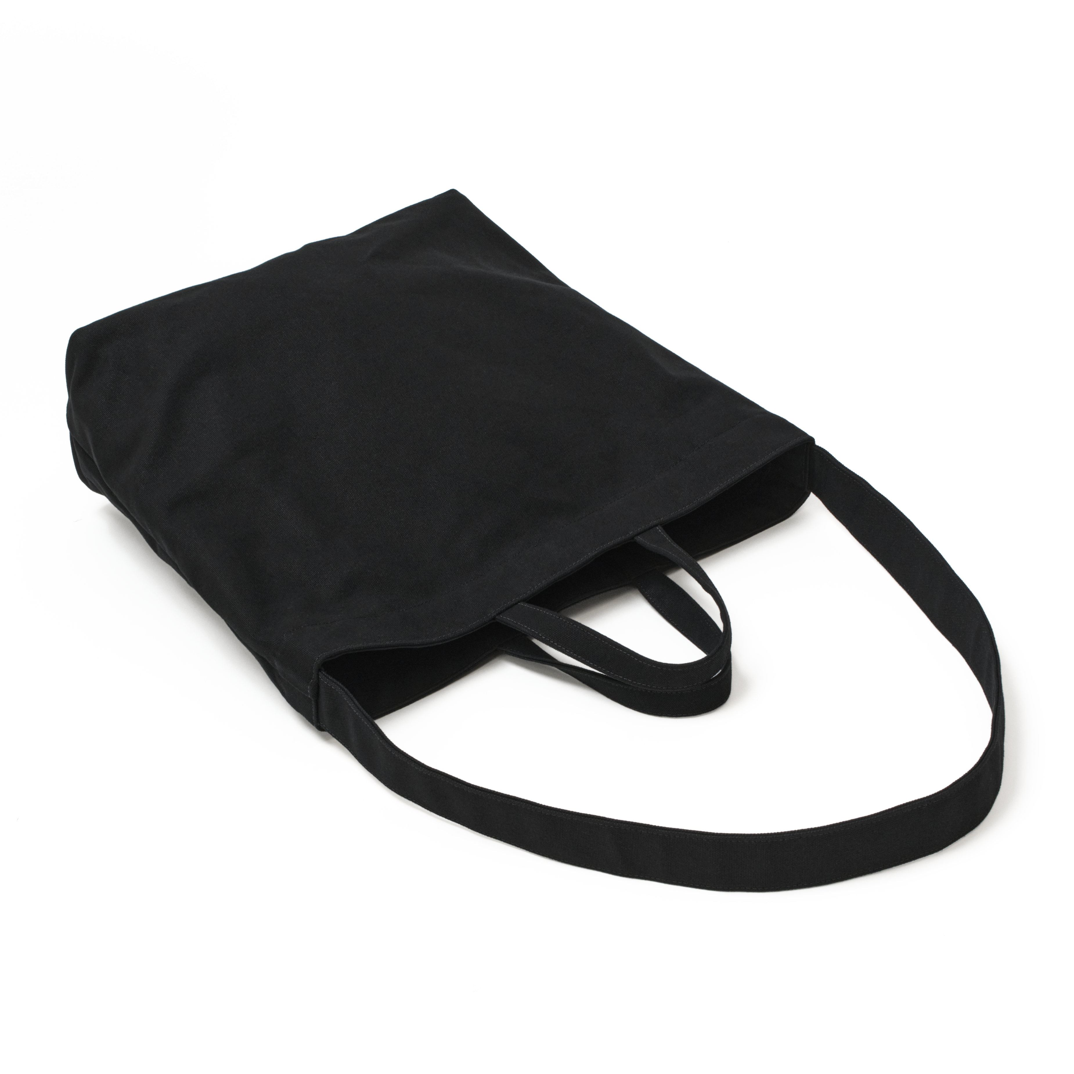 The MAKR Vert Sling Tote in Black heavy cotton duck canvas, shown at an angle.