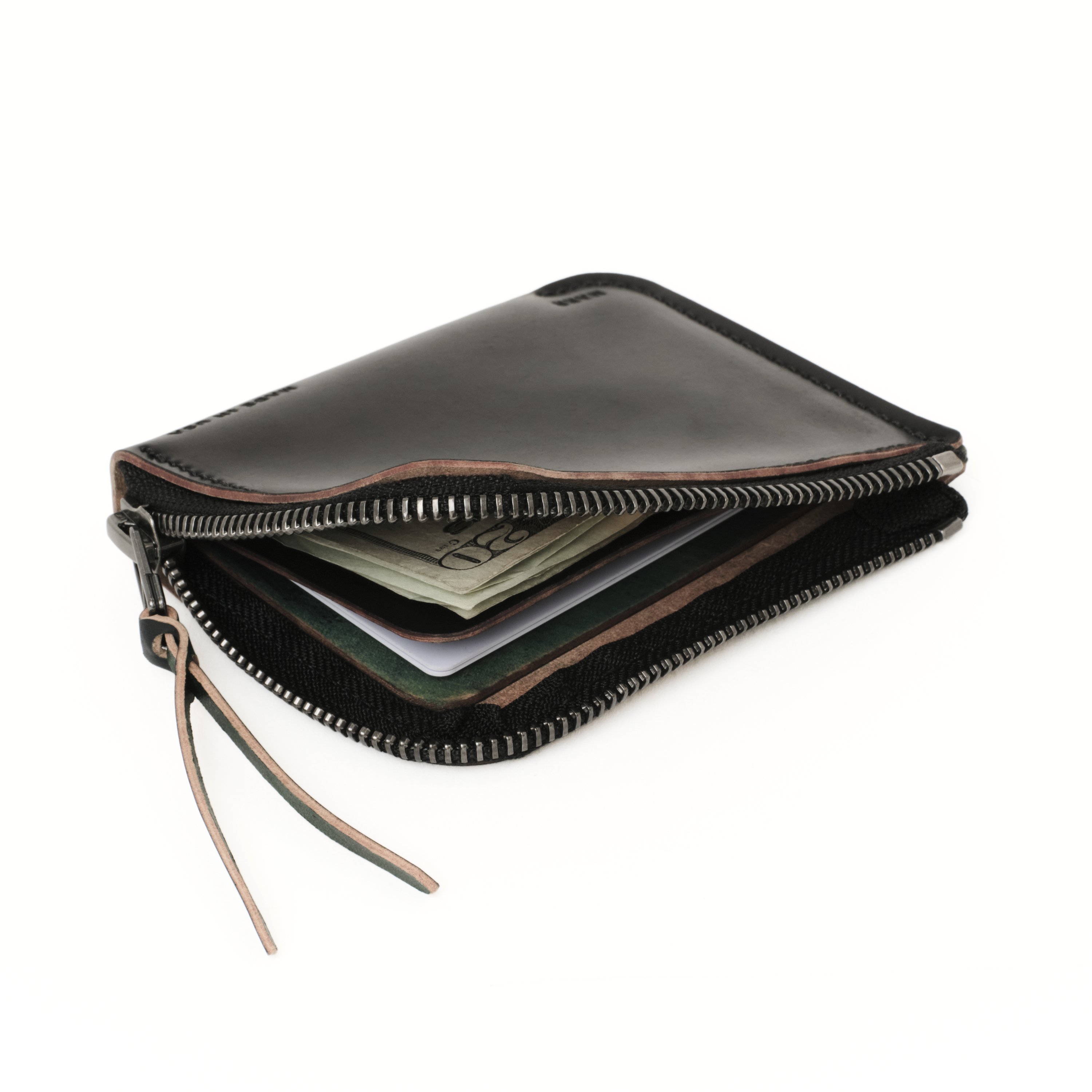 Angled view of the MAKR Cordovan Zip Luxe V2 Wallet in Black Horween Shell Cordovan, unzipped.