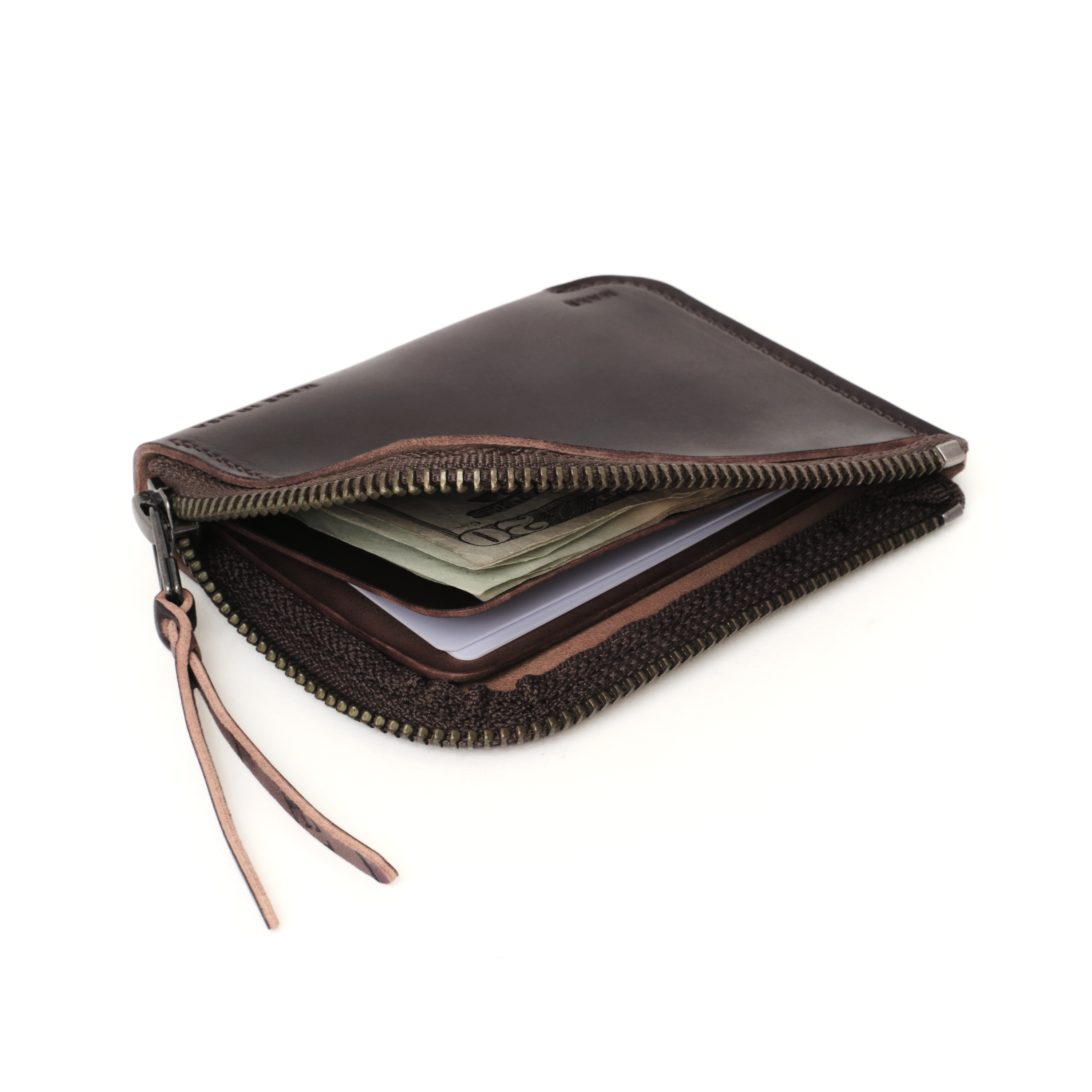 Angled view of the MAKR Cordovan Zip Luxe V2 Wallet in Ox Blood Horween Shell Cordovan, unzipped.