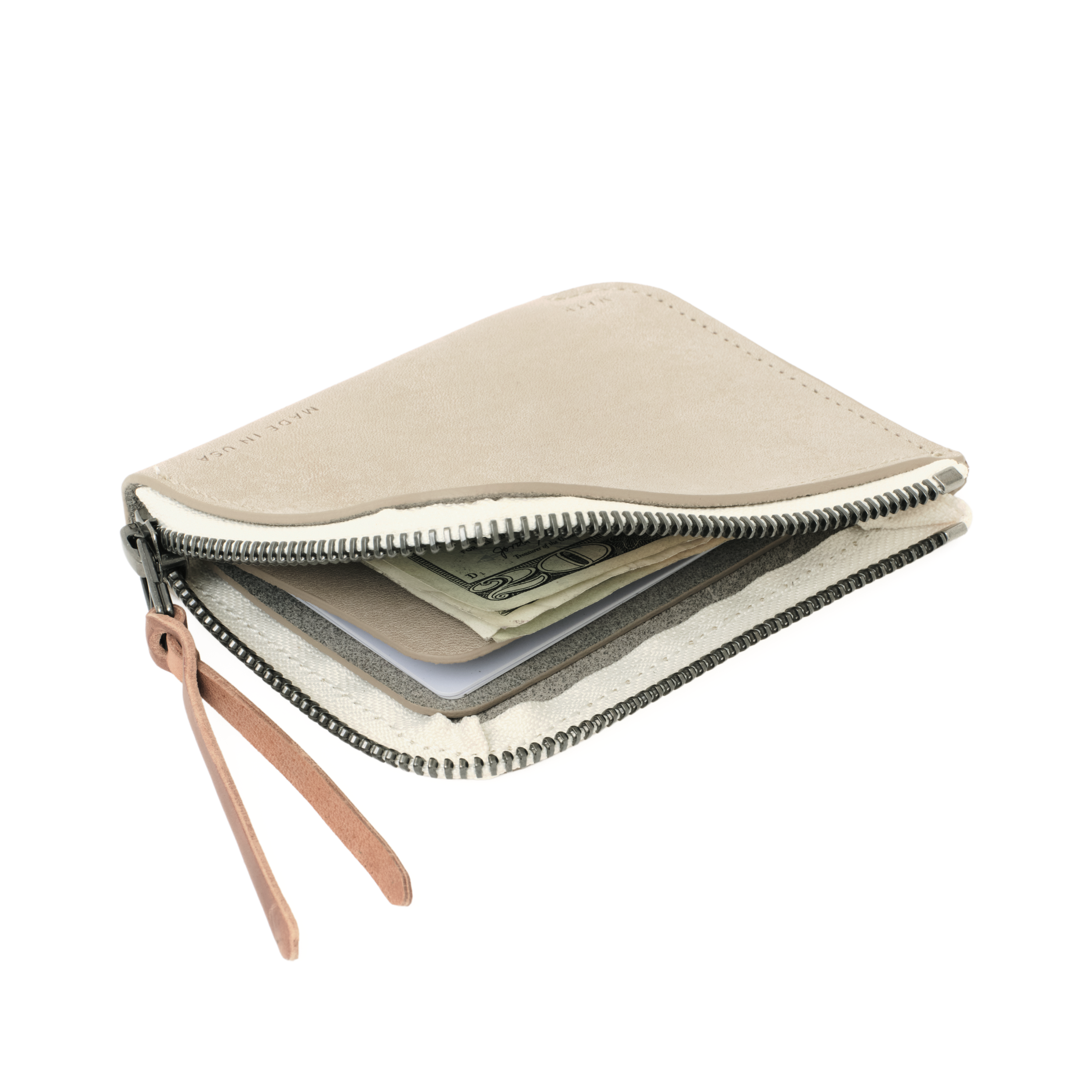 Angled view of the MAKR Zip Luxe V2 Wallet in Smooth Stone Horween leather, unzipped.
