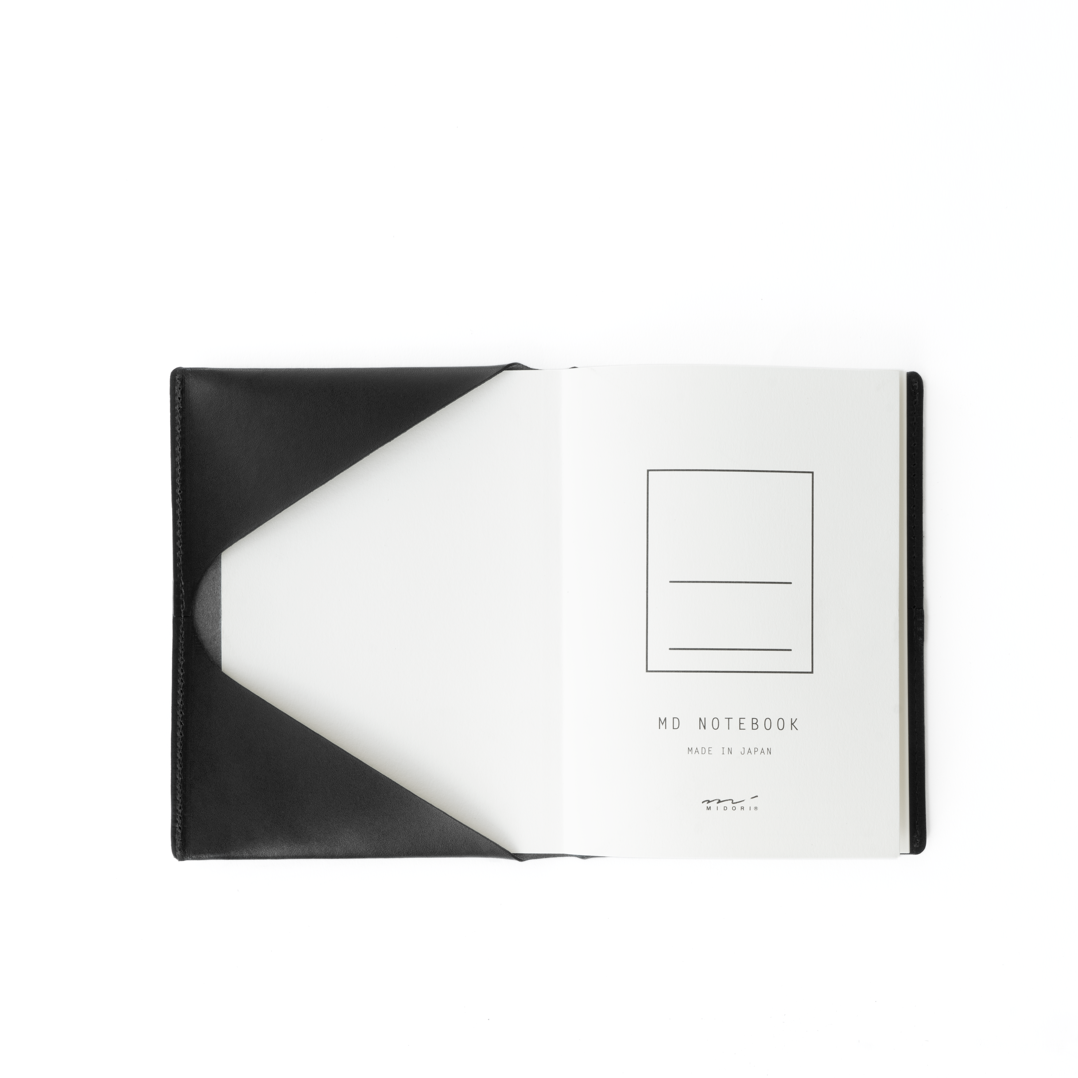 The MAKR Midori Cover SM (A6) in Black Horween Latigo leather, opened flat with a notebook inside.