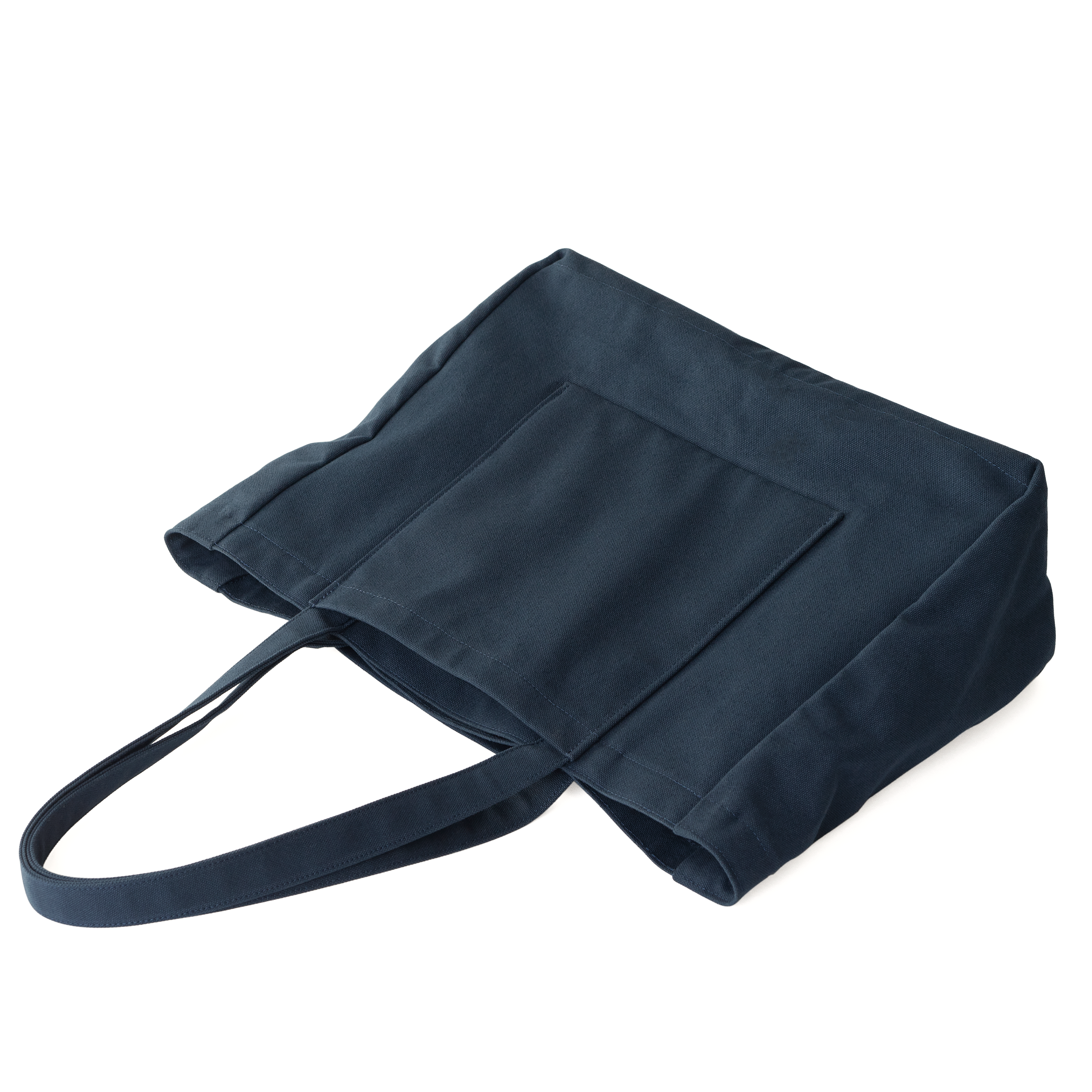 Angled view of the MAKR Offset Tote in carbon blue cotton duck showing the handle pocket.